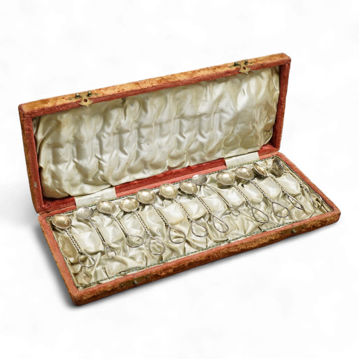 A cased set of twelve assorted white metal coffee spoons, with spiral stems and coin bowls.